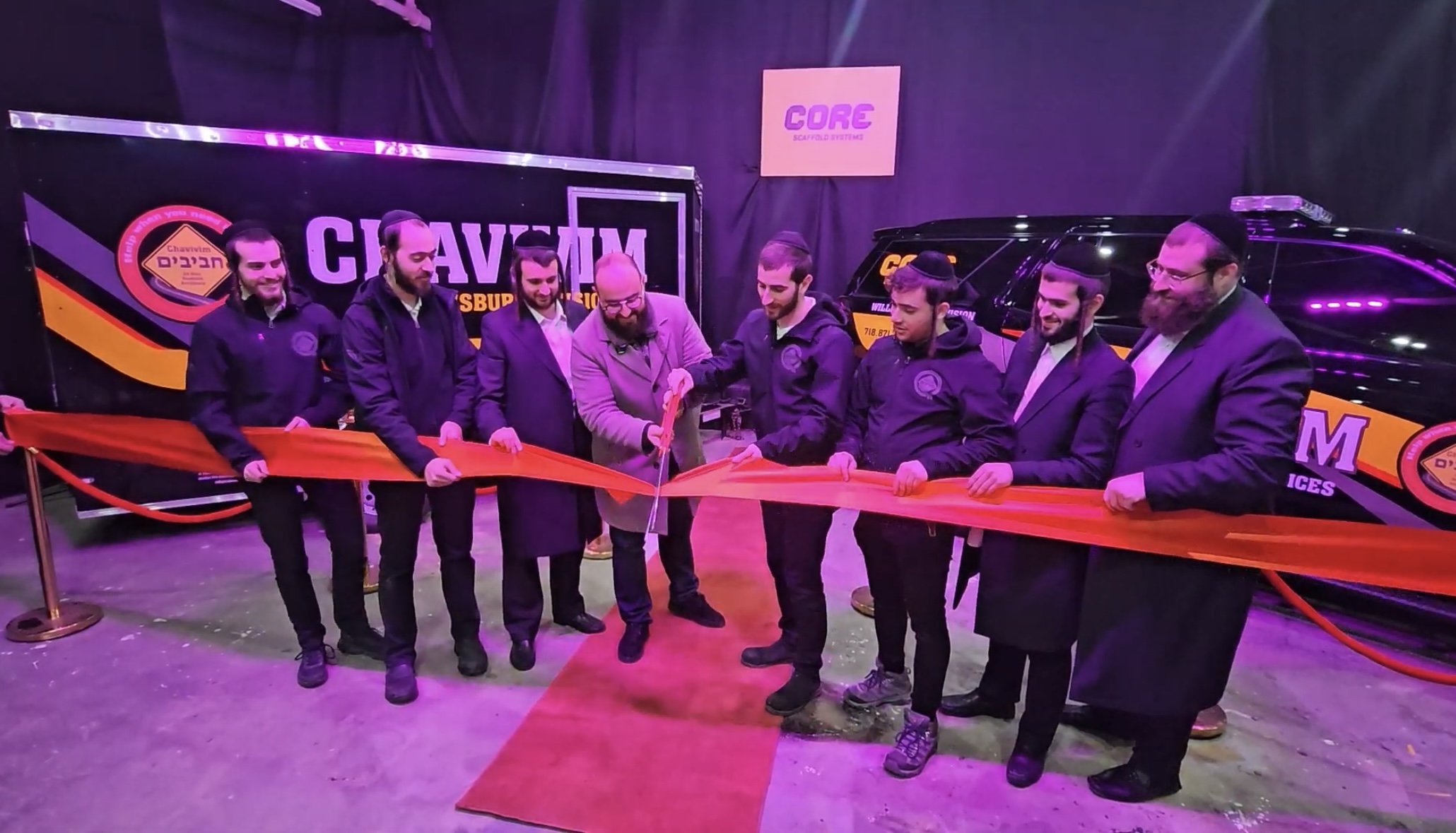 Chavivim Williamsburg members and Core Scaffold Systems representatives cutting the ribbon in front of W-901 at the unveiling ceremony
