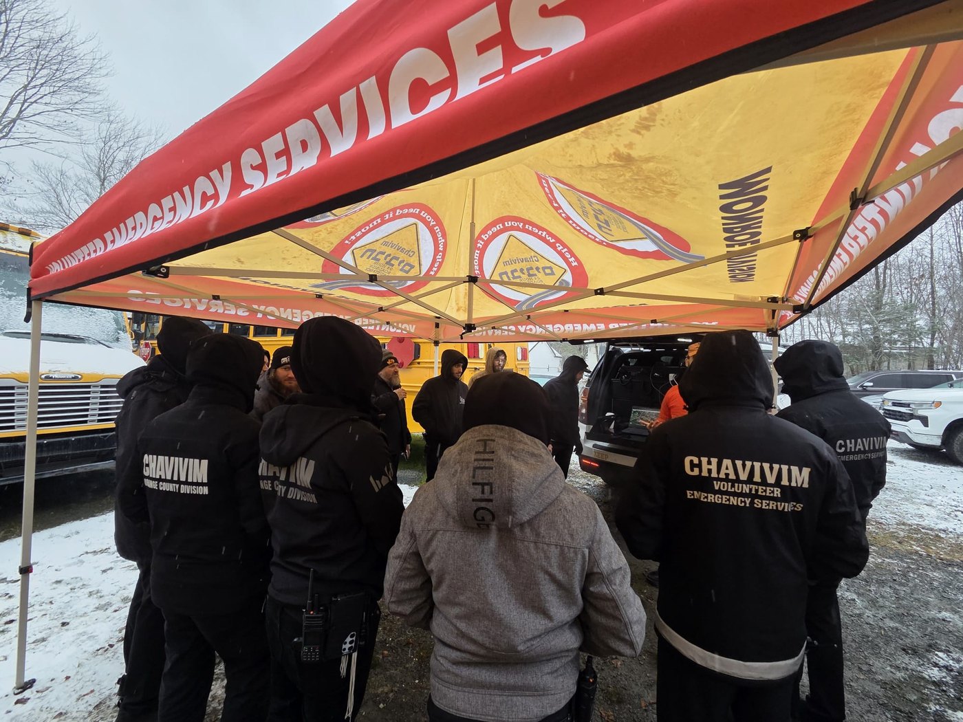Chavivim SAR members under an emergency services tent during a winter operation